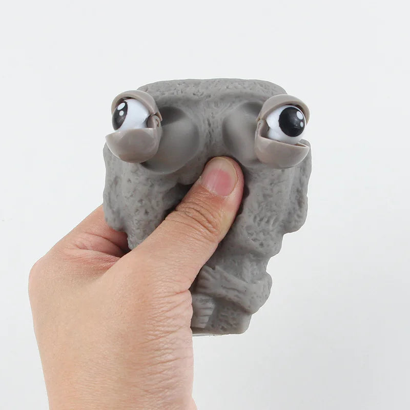 Stone man releases stress toy slowly rebounds soft Moai statue squeeze eyes interested expression relaxes stress children's gift