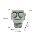 Stone man releases stress toy slowly rebounds soft Moai statue squeeze eyes interested expression relaxes stress children's gift