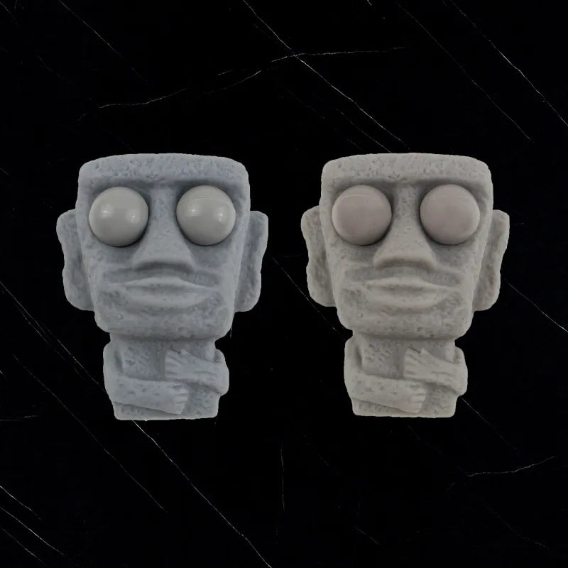 Stone man releases stress toy slowly rebounds soft Moai statue squeeze eyes interested expression relaxes stress children's gift