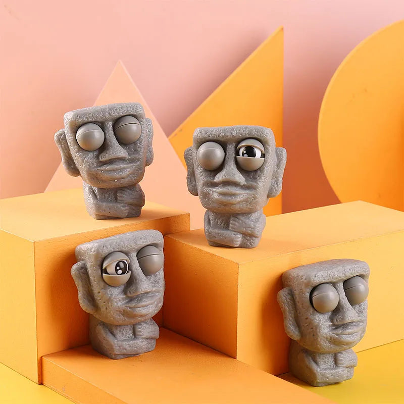 Stone man releases stress toy slowly rebounds soft Moai statue squeeze eyes interested expression relaxes stress children's gift
